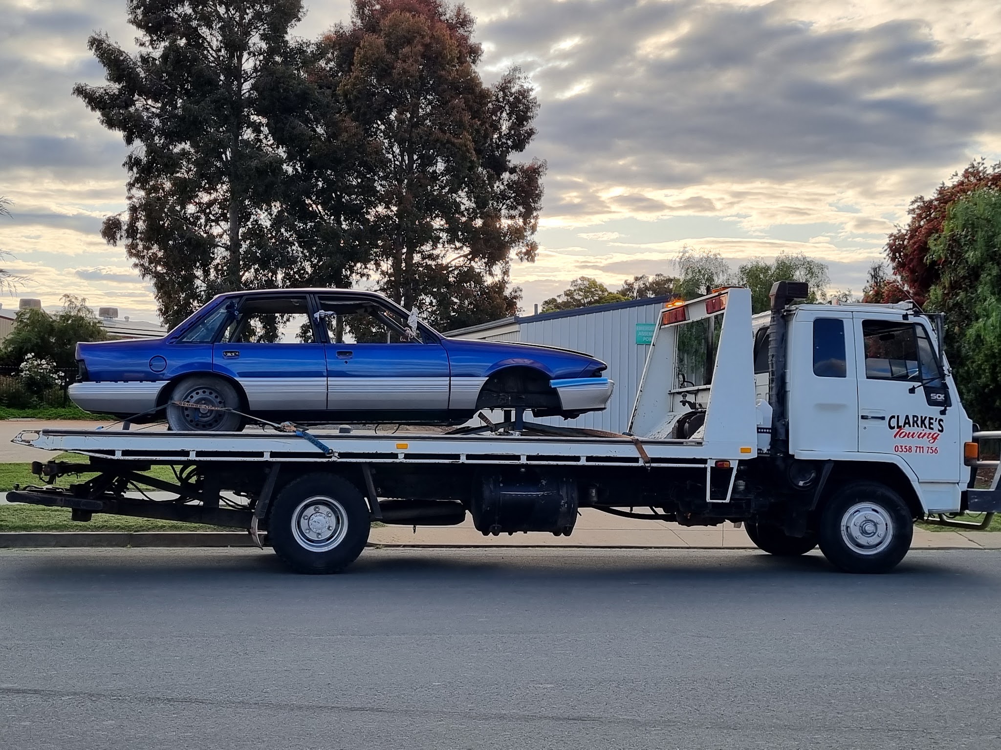 Stripped blue Holden Commodore project car on the Clarke's Towing flatbed
